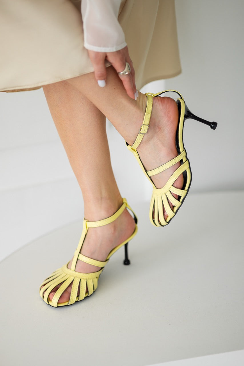 Light beige leather sandals featuring a leather-covered heel and sole