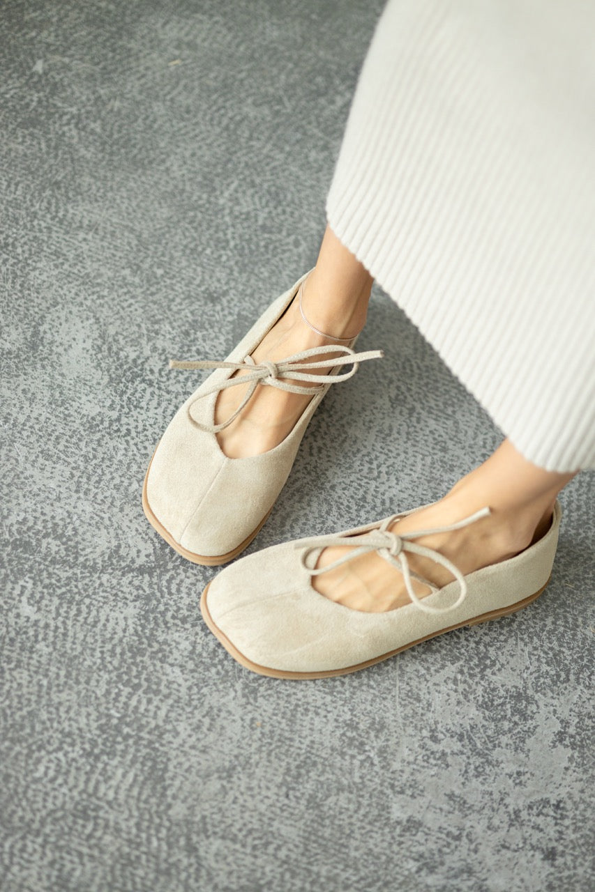 Beige suede flats close up
