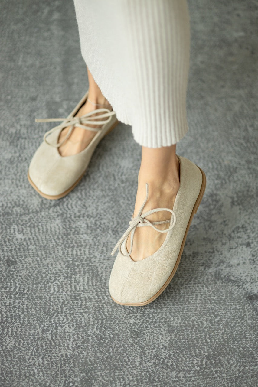 Blue suede flats on feet