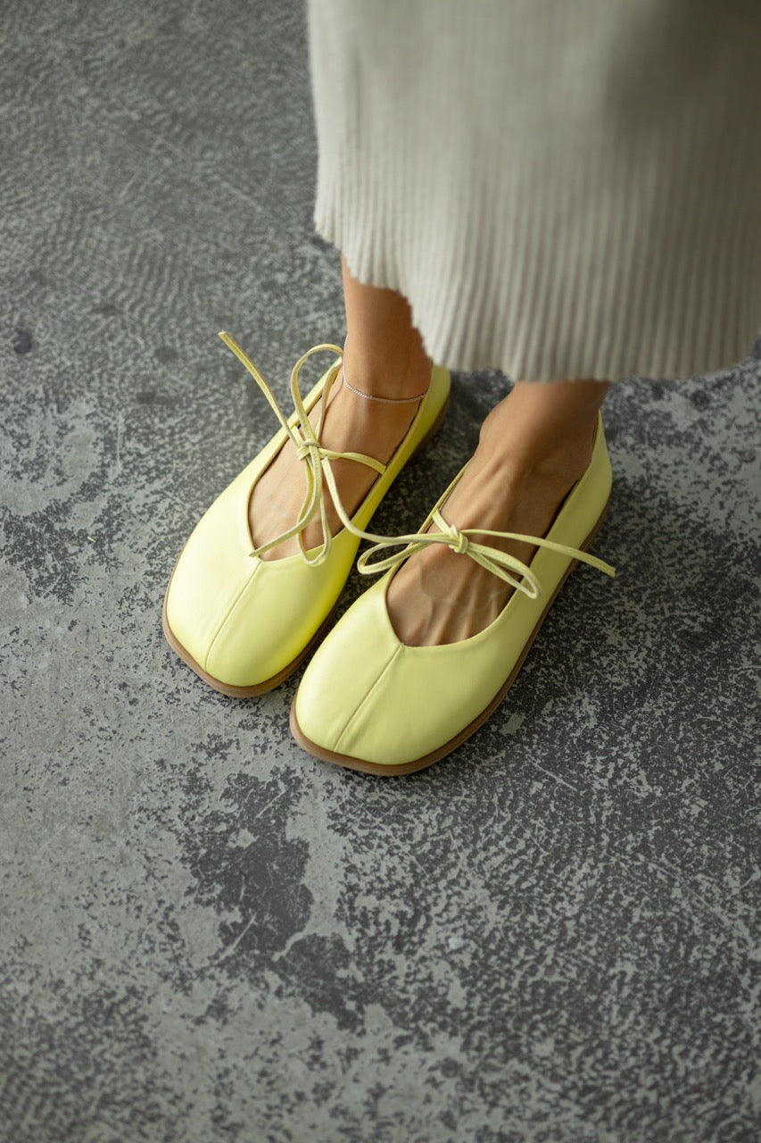 Yellow leather flats front view