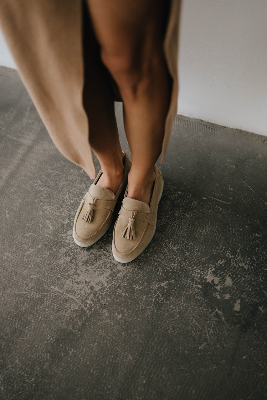 Beige suede women’s loafers with a flat sole and small heel, side view