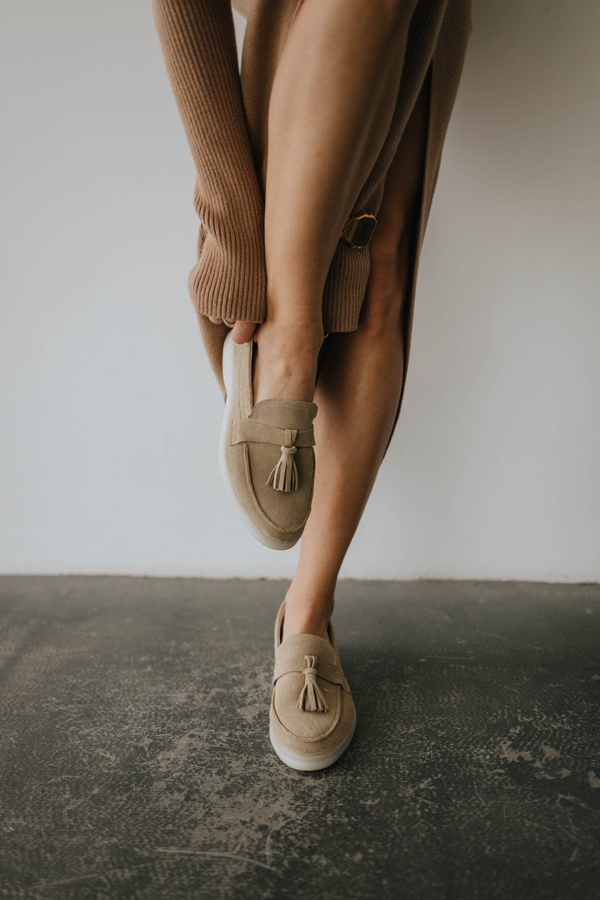 Close-up details of women’s loafers showing suede texture and small heel