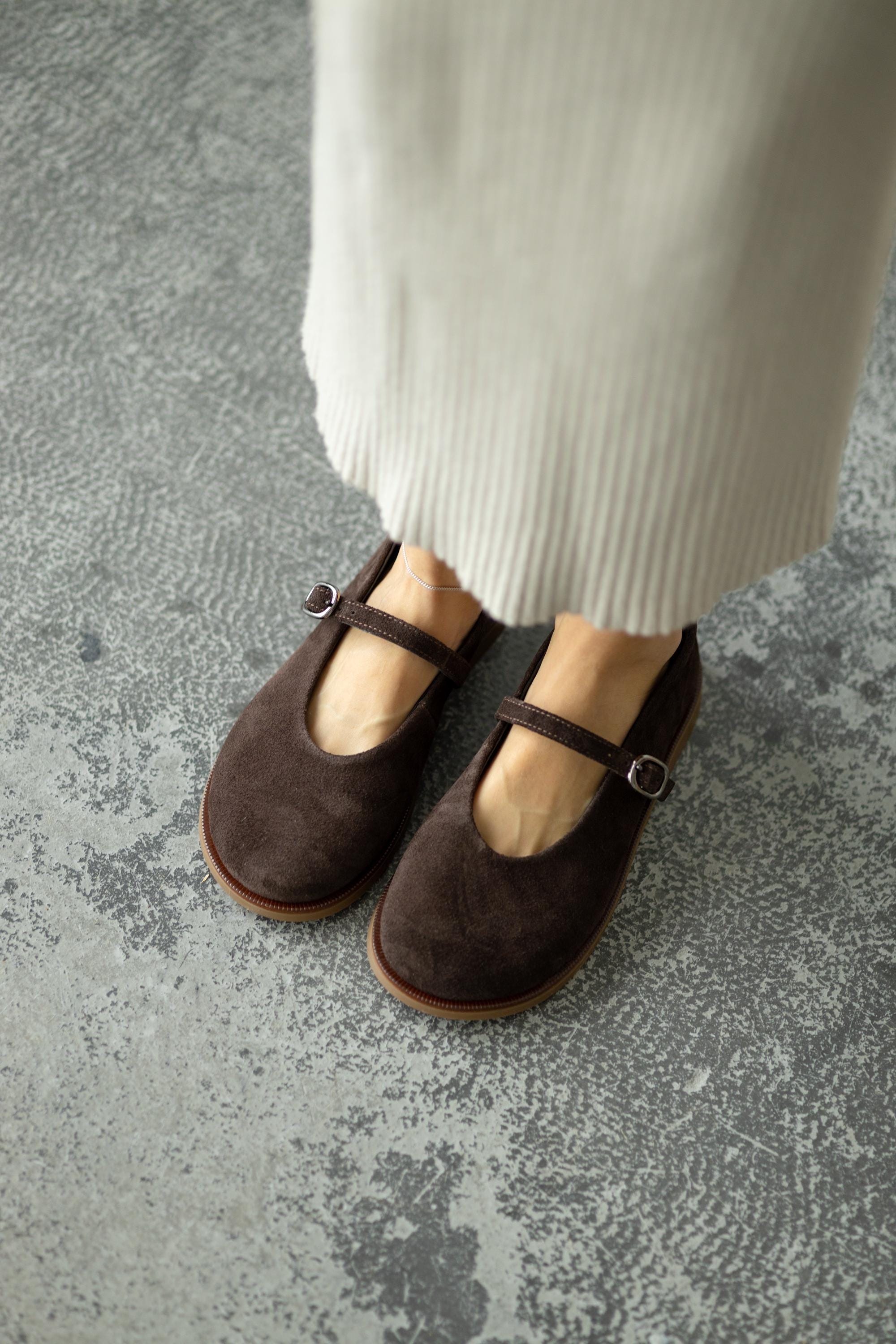 Brown suede flats with buckle strap front view