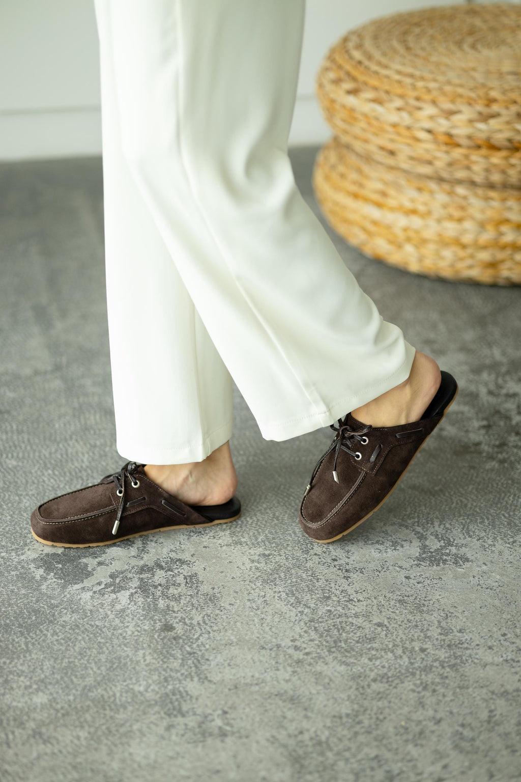 Beige suede mules with front lacing detail close-up