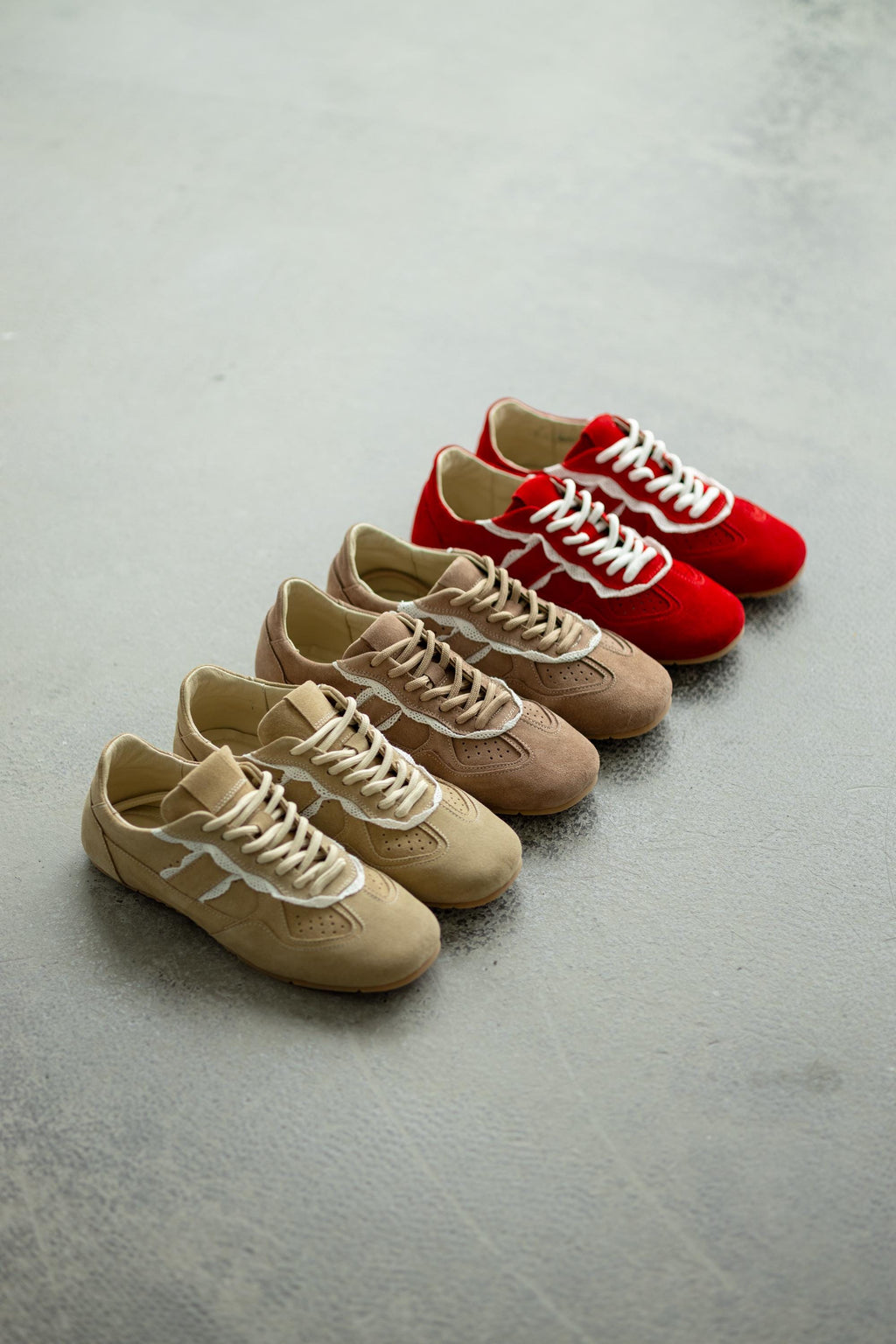 Beige suede sneakers with lace detail side view
